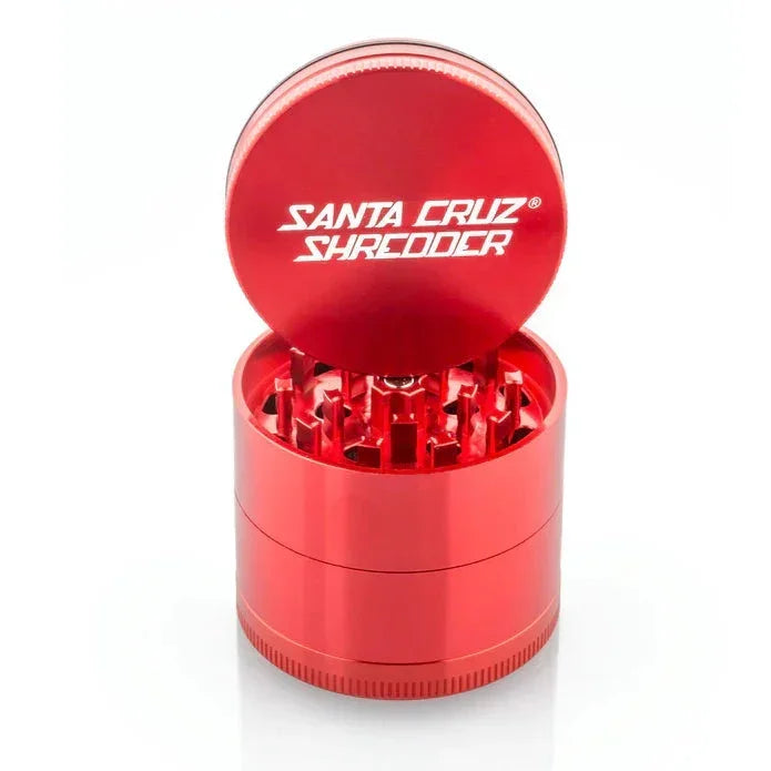 Red Santa Cruz Shredder herb grinder with open lid, teeth exposed, on white background.
