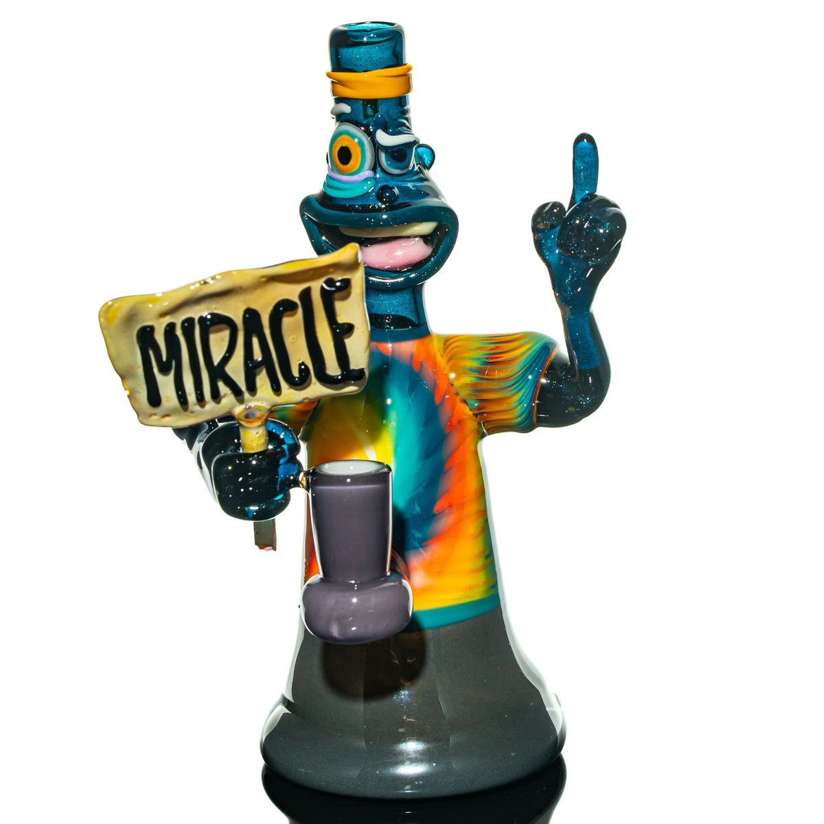 Colorful glass water pipe shaped like a cartoon character holding a 'miracle' sign, tie-dye shirt