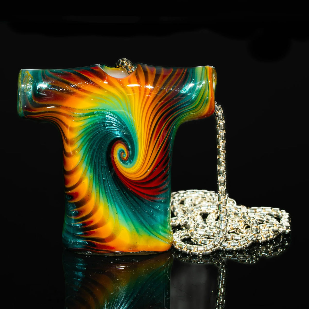 Colorful glass pendant in T-shirt shape with swirling rainbow pattern and silver chain