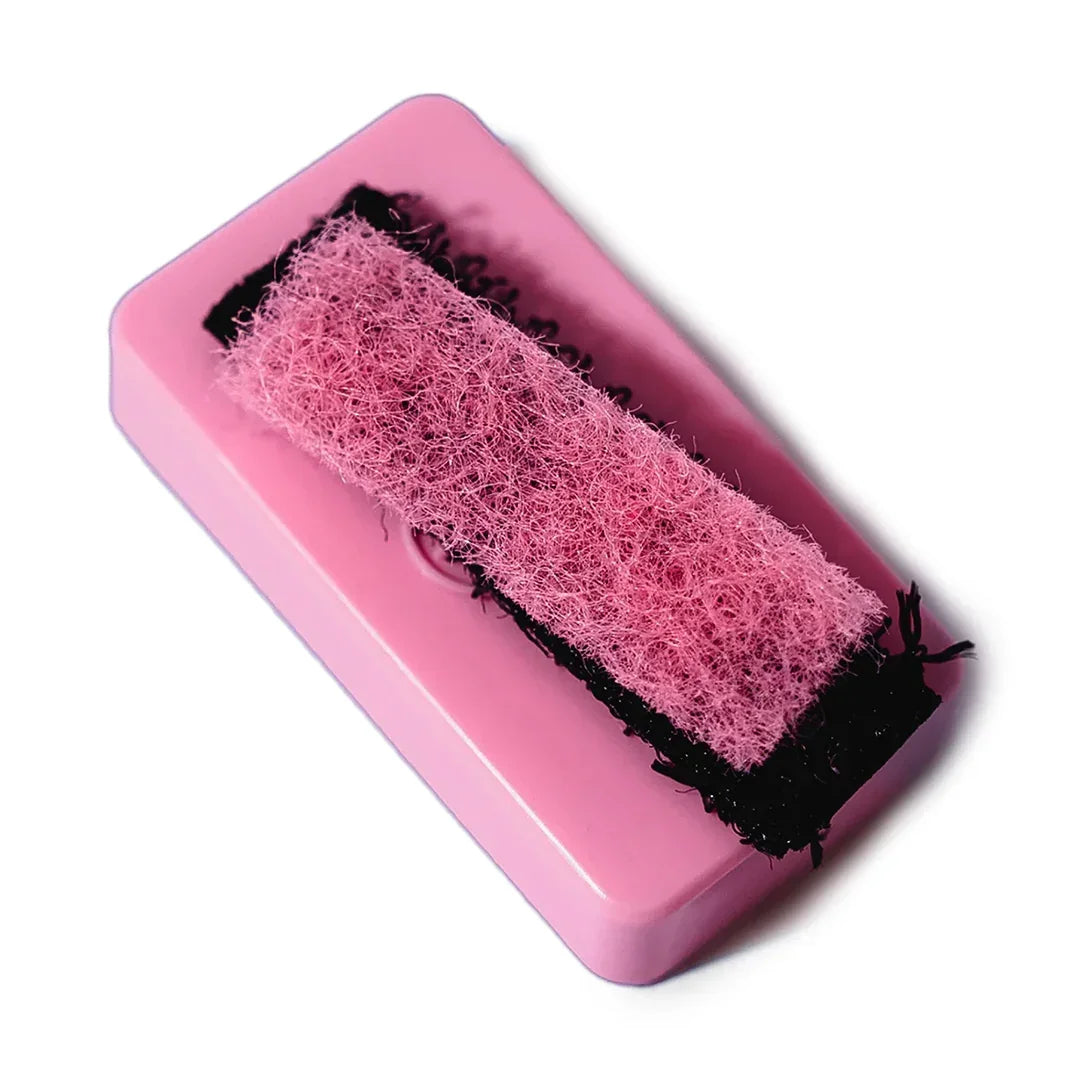 Pink resin cleaning scrubber for glass pipes and accessories on white background