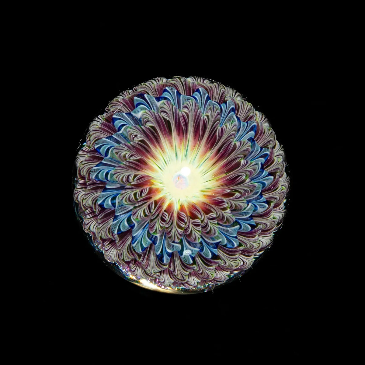 UV reactive glass art flower marble with intricate swirl patterns, black background