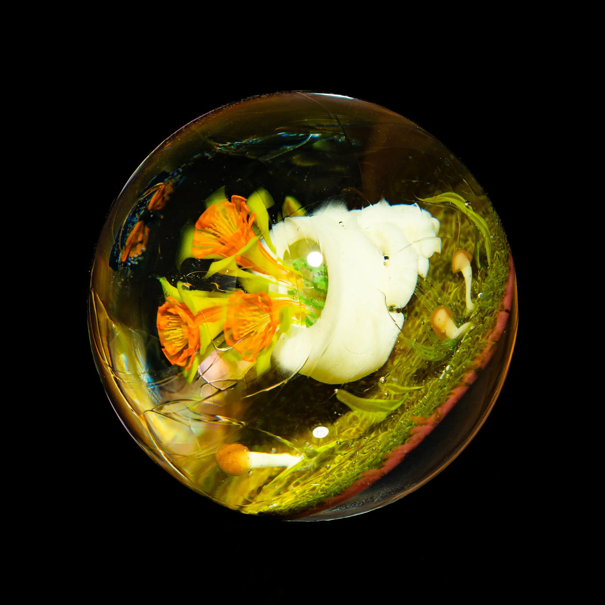Handcrafted glass marble with orange flowers and white mushroom design on black background