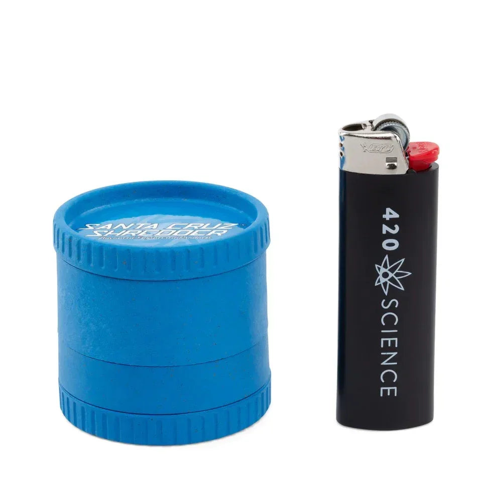 Blue biodegradable hemp grinder and black lighter on white background