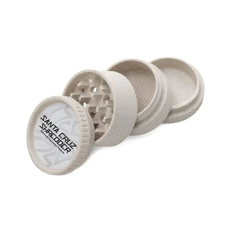 Four-piece biodegradable hemp grinder with textured beige finish, shown disassembled.