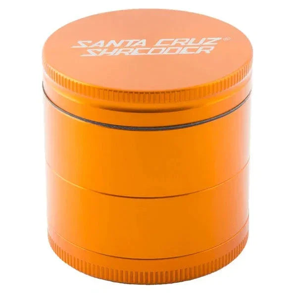 Medium orange metal herb grinder with Santa Cruz Shredder logo on lid