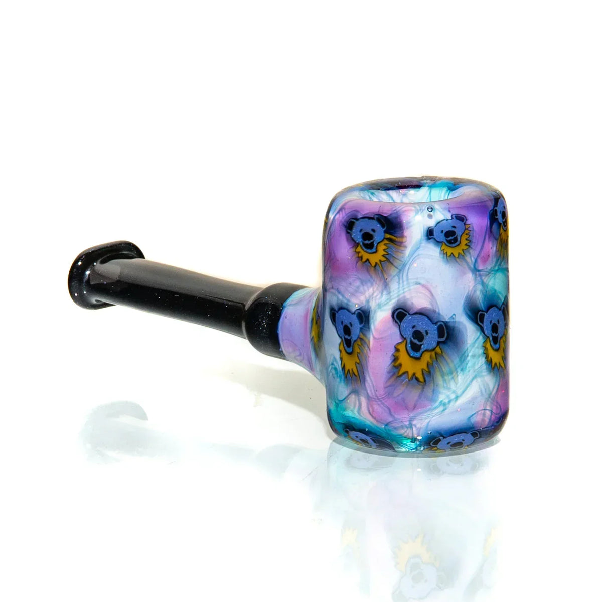 Colorful glass hand pipe with bear face designs and black handle on white background