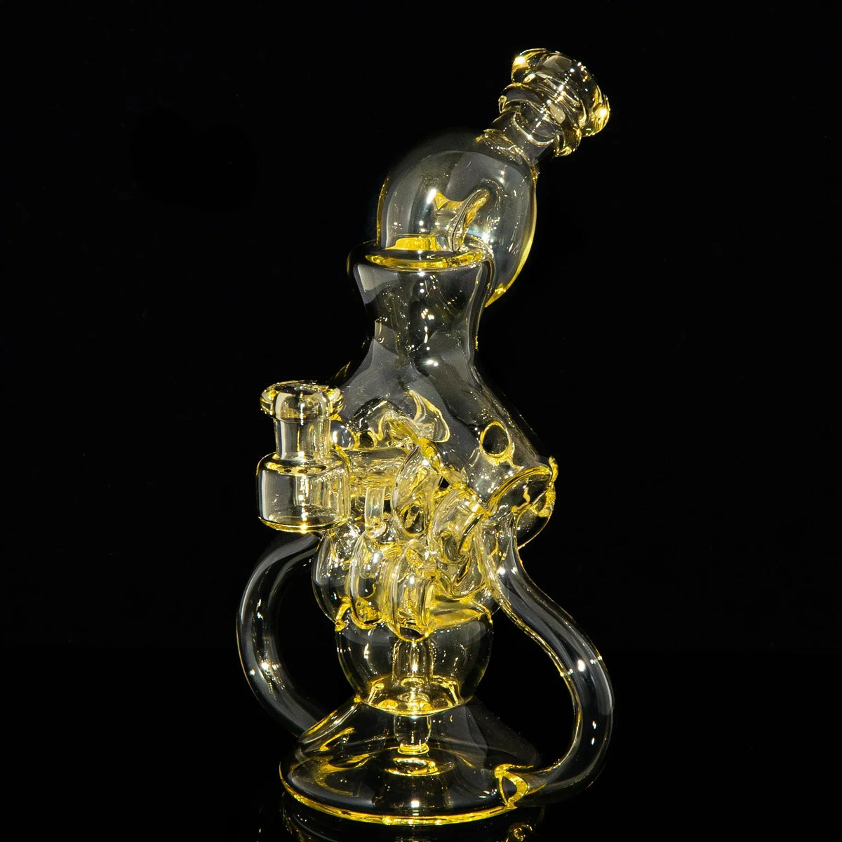 Intricate yellow-tinted glass recycler rig with unique twisted design on black background