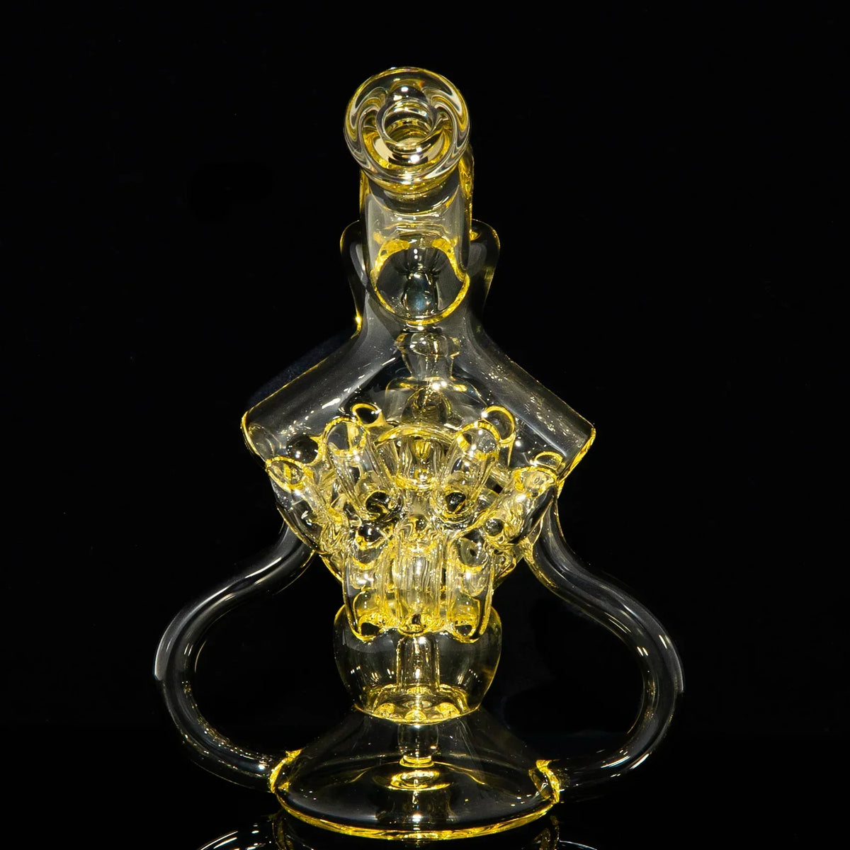 Intricate yellow glass water pipe with detailed percolator on black background