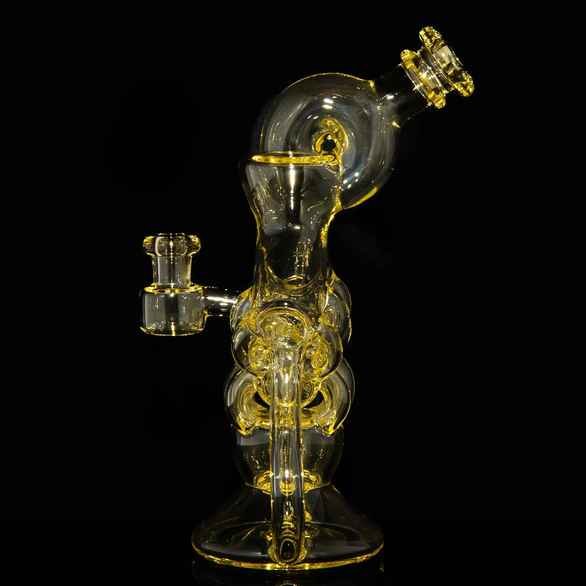 Intricate yellow glass water pipe with recycler design on black background