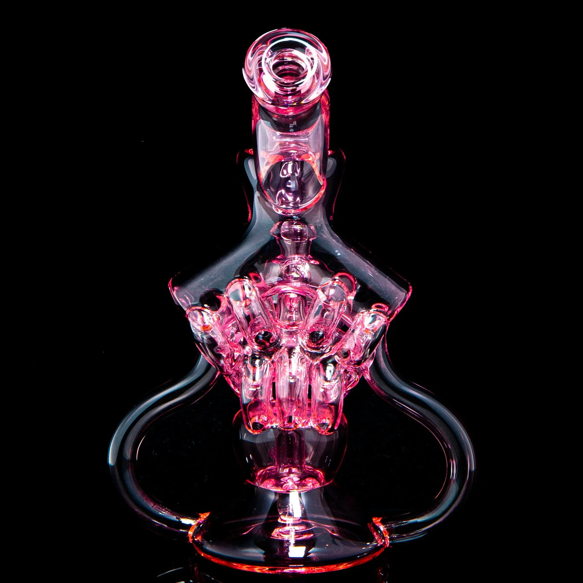 Intricate pink glass water pipe with artistic design on black background