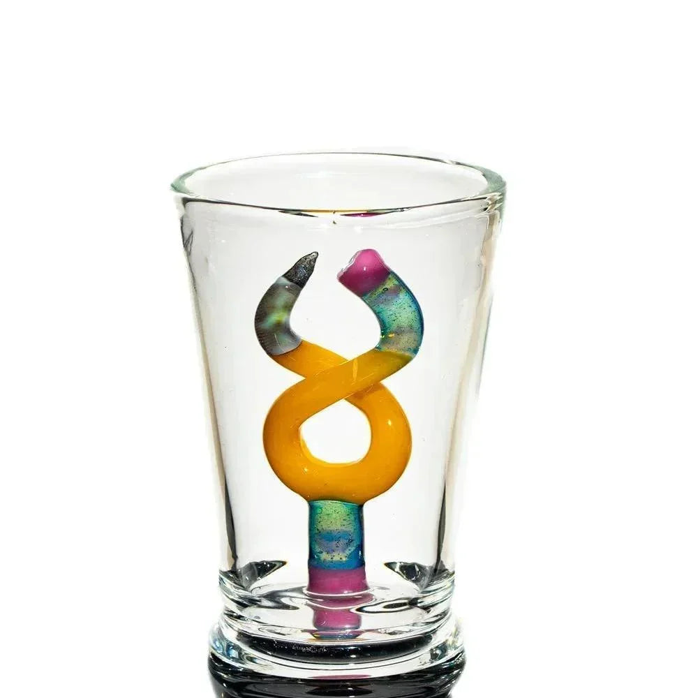 Handcrafted glass cup with colorful twisted yellow and rainbow art inside
