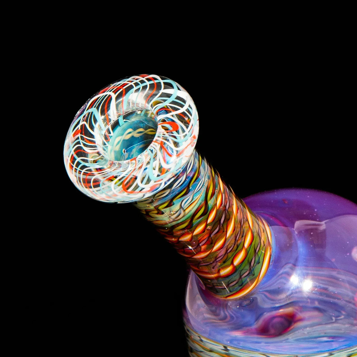 Close-up of a colorful heady glass water pipe neck with intricate spiral designs, black background