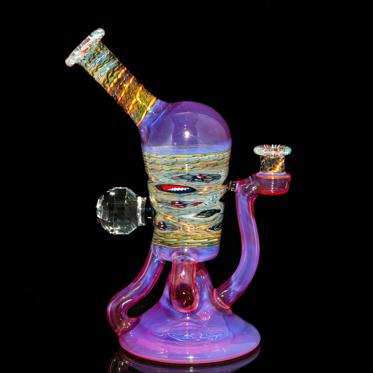 Heady glass water pipe with colorful swirls and intricate patterns on a black background