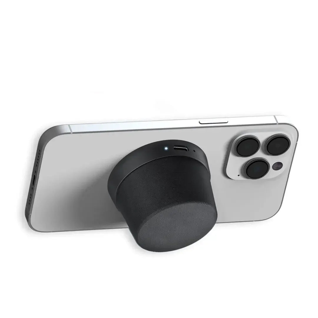 Wireless portable speaker magnetically attached to the back of a smartphone