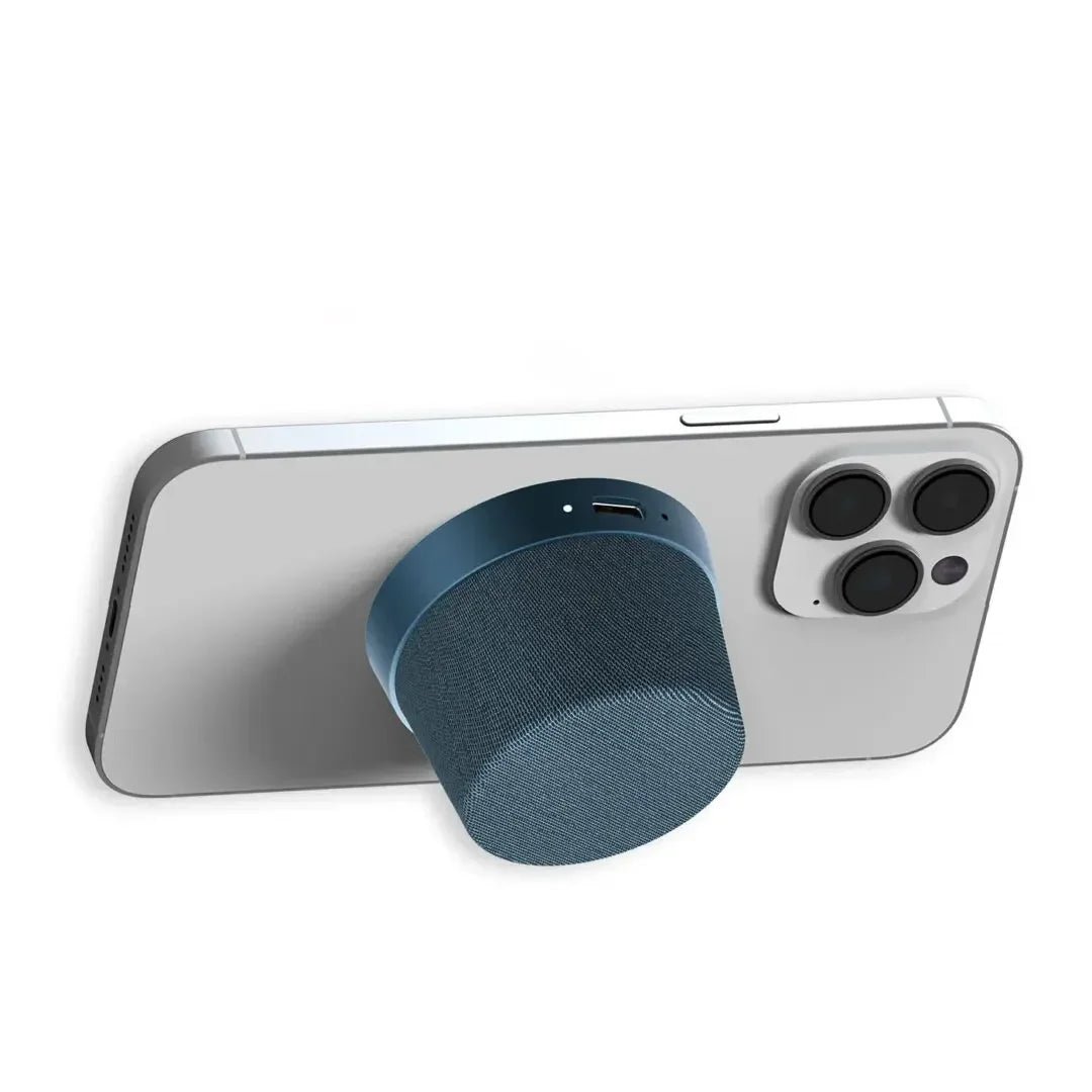 Magnetic portable Bluetooth speaker attached to back of smartphone.