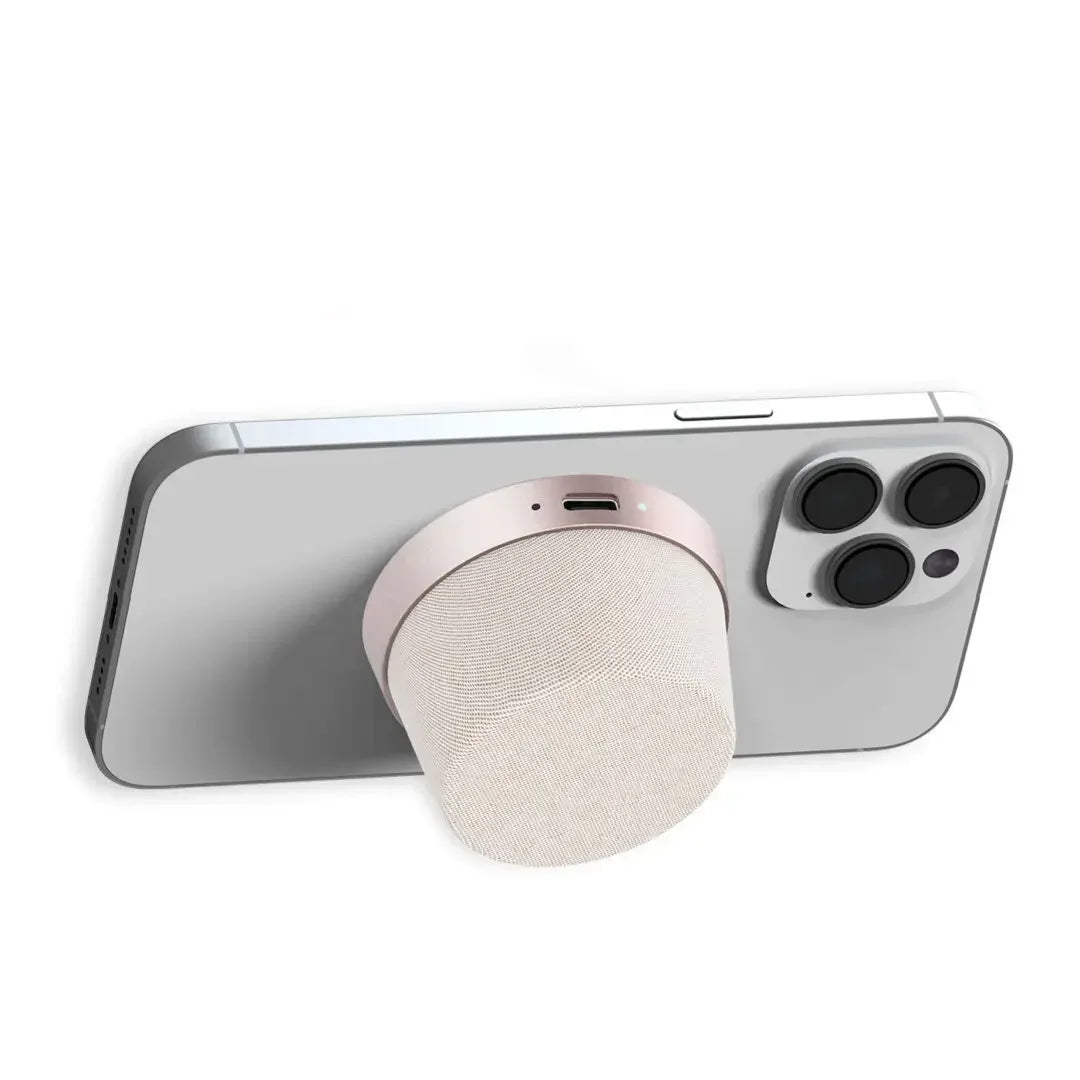 Magnetic portable Bluetooth speaker attached to smartphone with triple camera