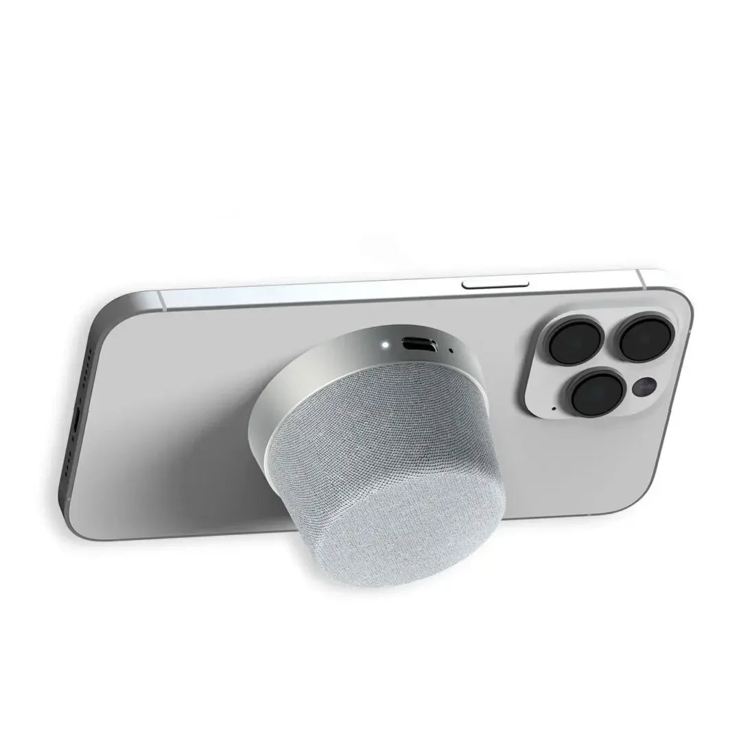 Magnetic portable Bluetooth speaker attached to the back of a smartphone