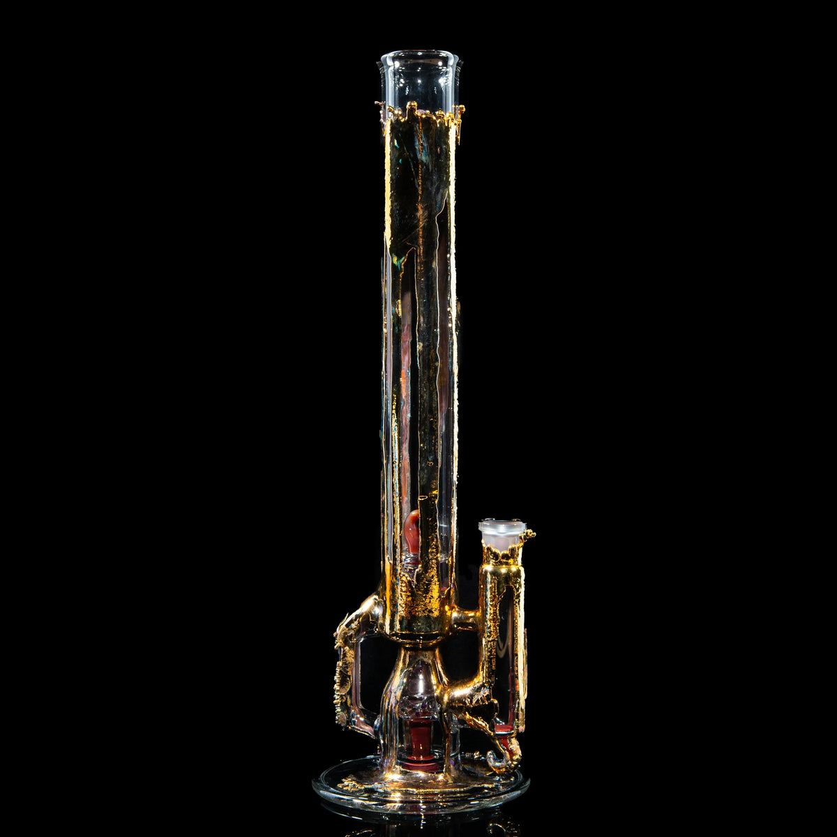 Gold-accented clear glass water pipe with intricate design on black background