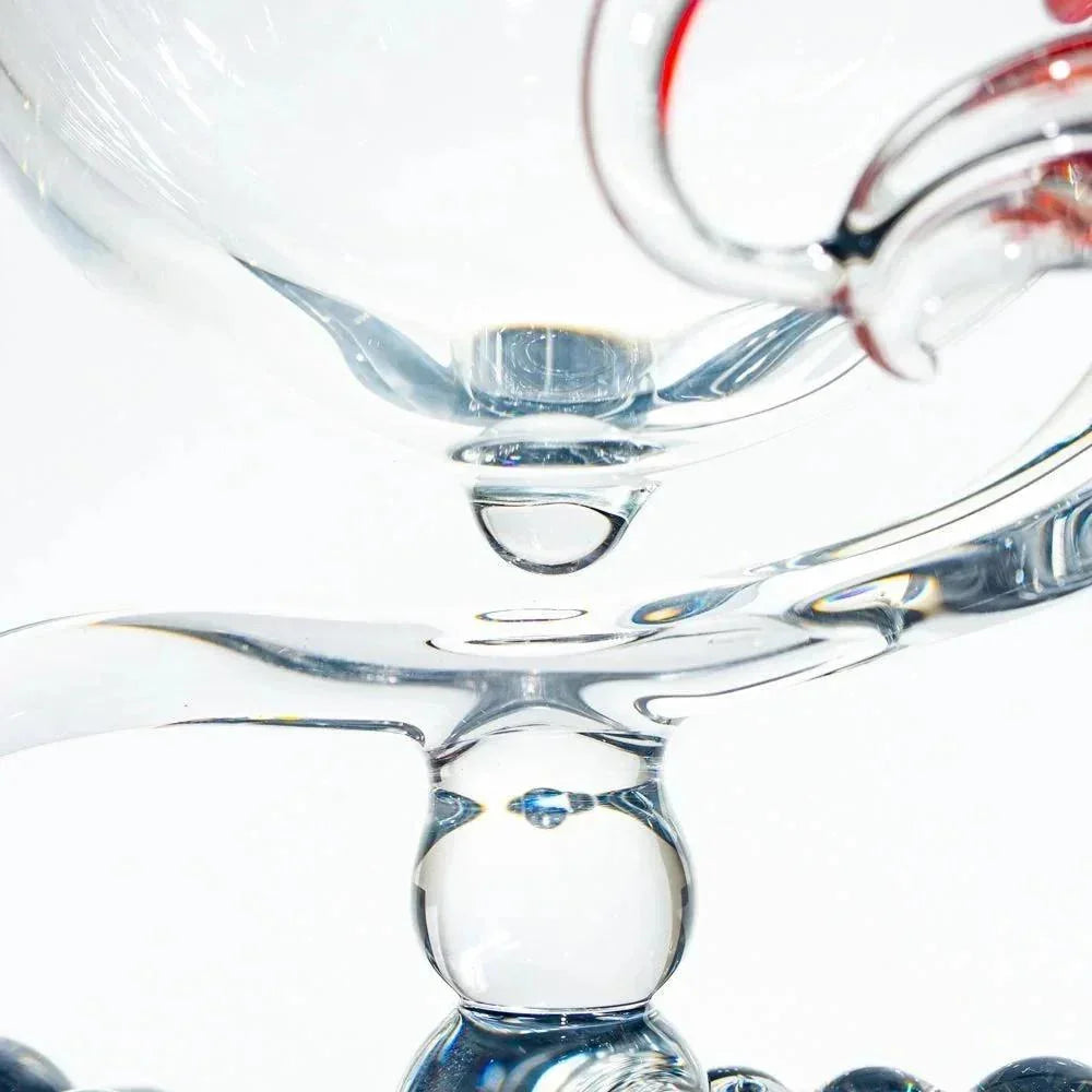Close-up of intricate clear glass art piece with curved and spherical elements