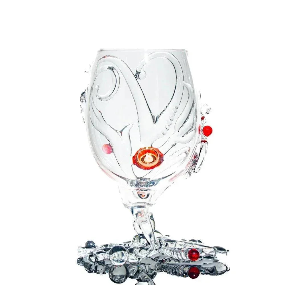 Handcrafted clear glass goblet with decorative swirls and red glass accents on base and bowl