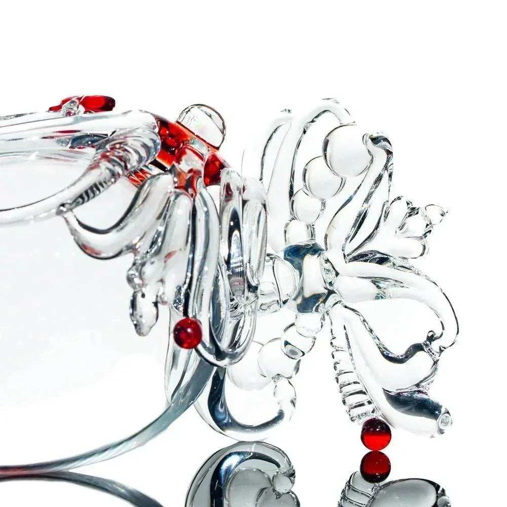 Heady glass pipe with intricate clear and red artistic details on a white background