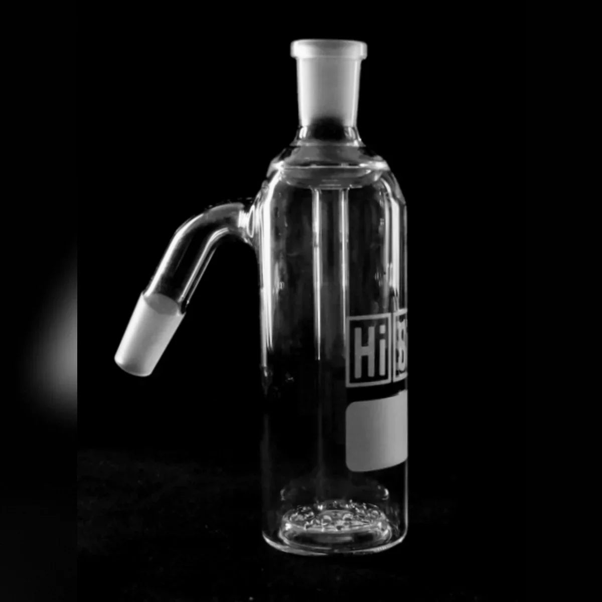 Clear glass ash catcher with angled joint on black background, smoking accessory