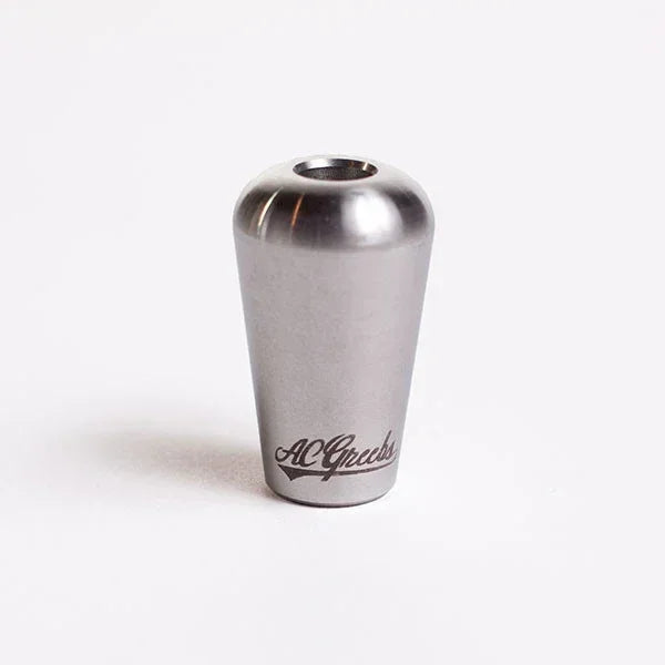 Stainless steel smoking accessory with engraved logo, conical shape on white background