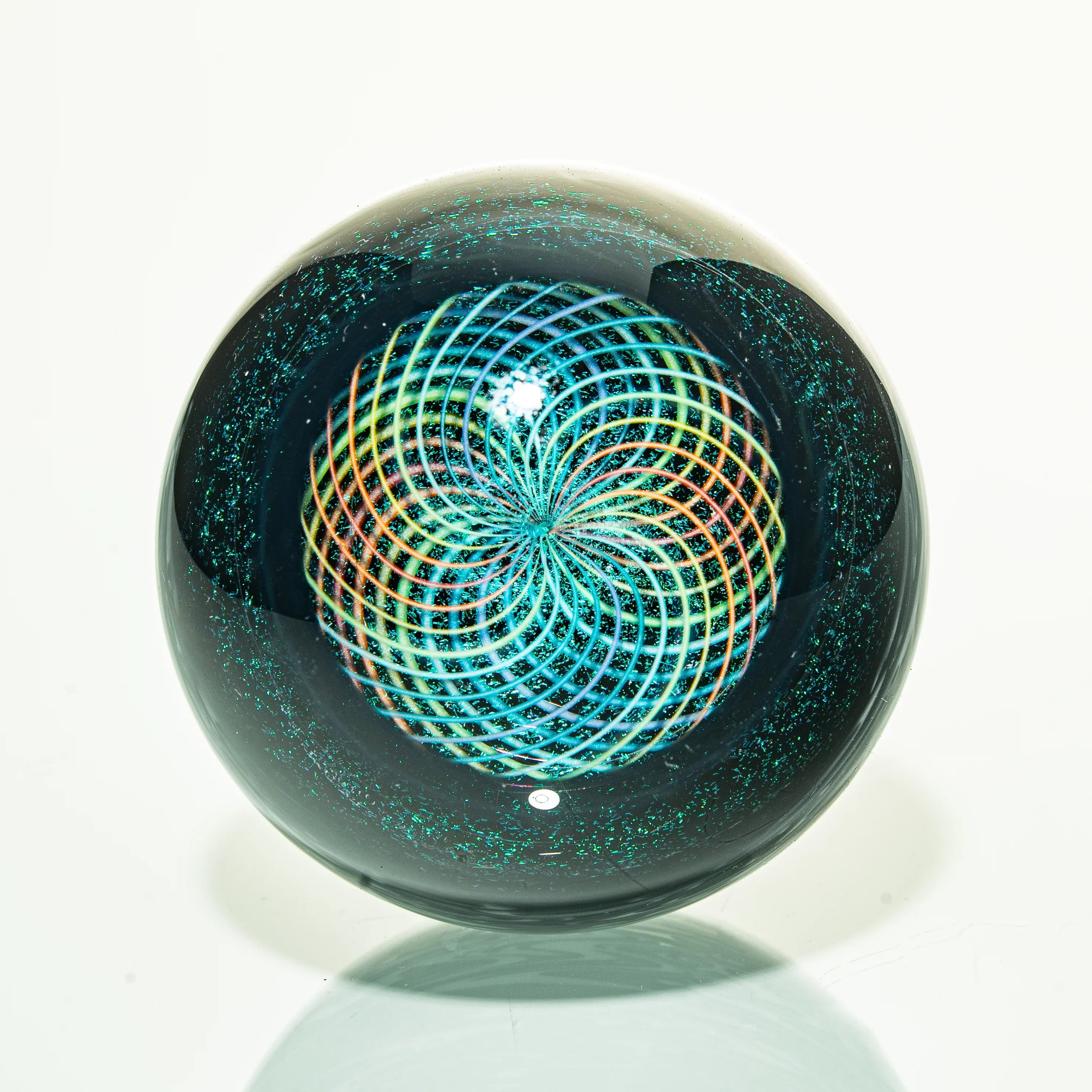 Heady glass marble with colorful spiral pattern and iridescent accents on white background