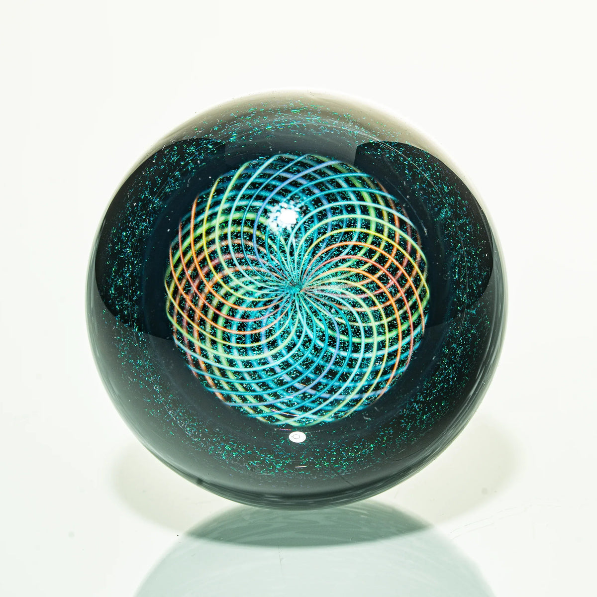 Heady glass marble with colorful spiral pattern and iridescent accents on white background