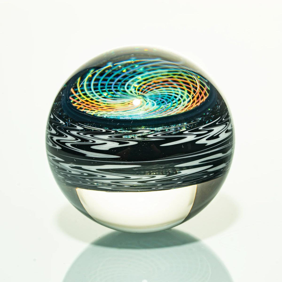 Colorful heady glass marble with spiral vortex design and intricate patterns on white background