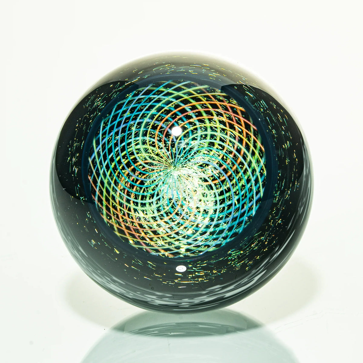 Handcrafted glass marble with intricate rainbow spiral pattern and reflective surface
