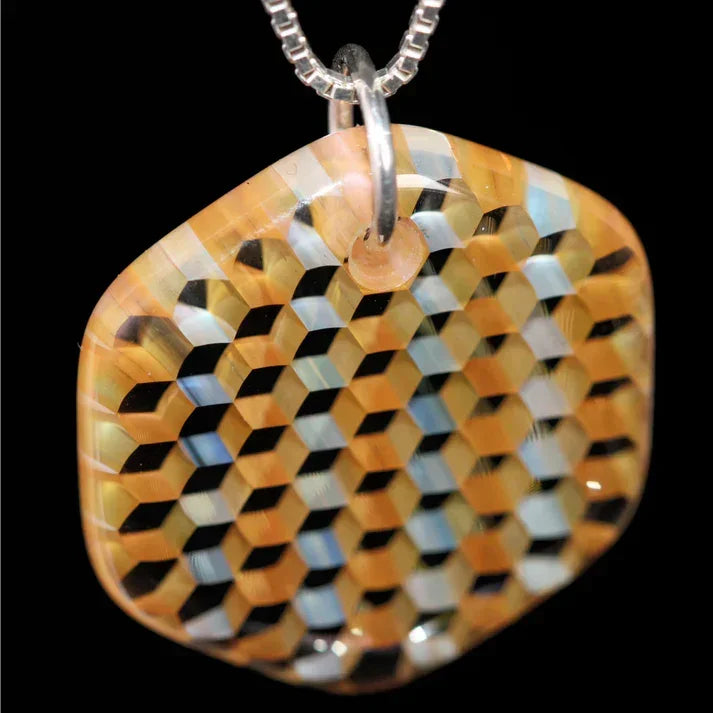 Colorful glass pendant with geometric striped hexagon pattern on a silver chain