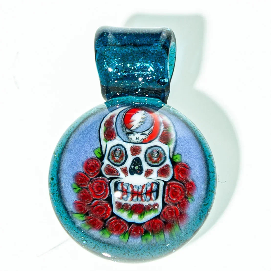 Handmade glass pendant with skull and red roses design, blue background, artisan jewelry