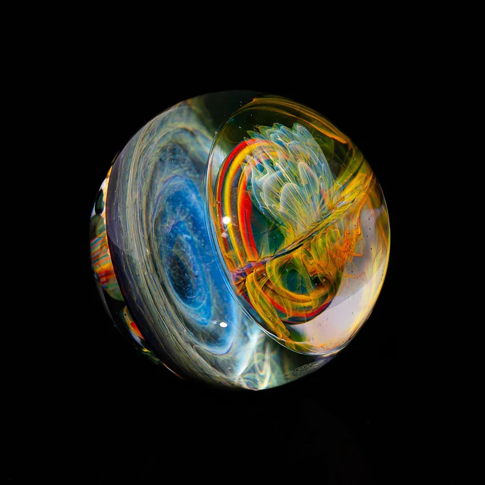 Heady glass marble with colorful swirls and flower-like patterns on black background