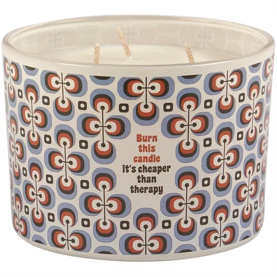 Three-wick candle with retro geometric pattern and text 'Burn this candle it’s cheaper than therapy'.