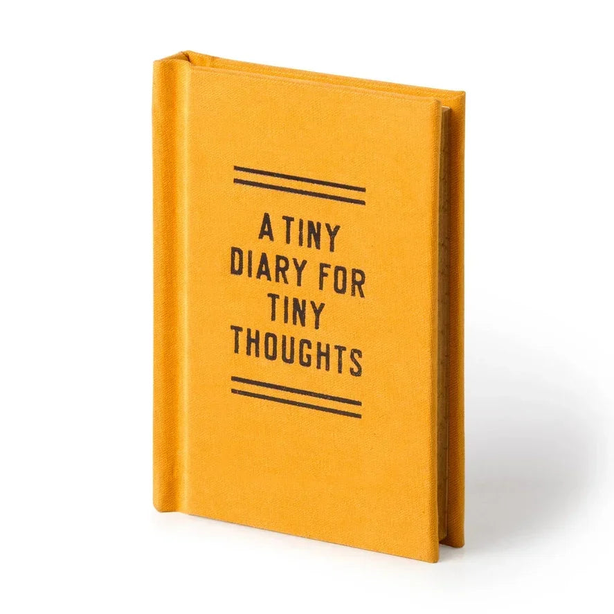 Small yellow diary with black text reading 'A Tiny Diary for Tiny Thoughts' on cover
