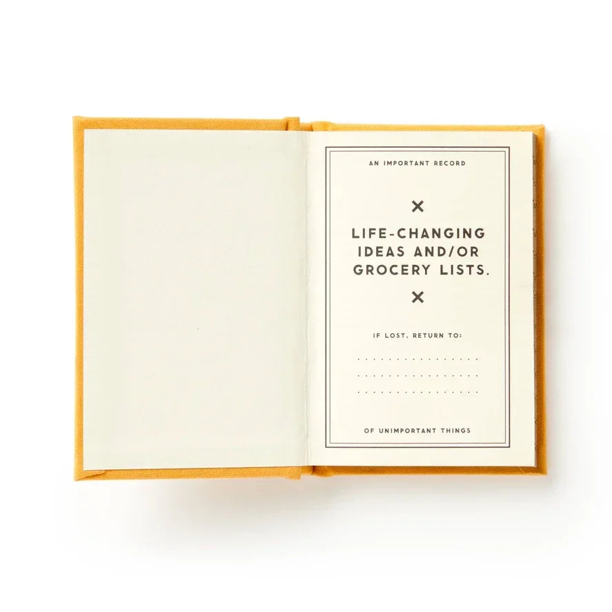 Open yellow notebook with printed text for recording ideas or grocery lists, minimal design.