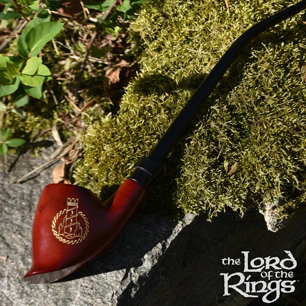 Lord of the Rings wooden smoking pipe with gold emblem on mossy stone outdoors