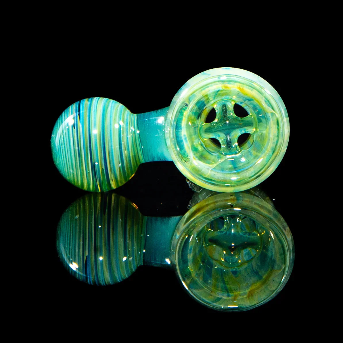 Colorful glass hand pipe with teal and yellow swirls, displayed on a reflective surface.
