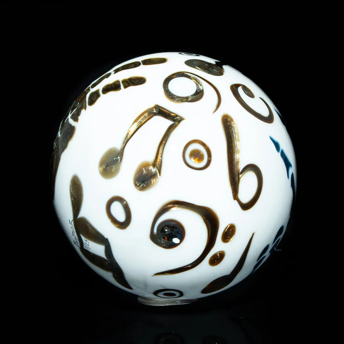 White marble with black musical note designs, glass art sphere on black background