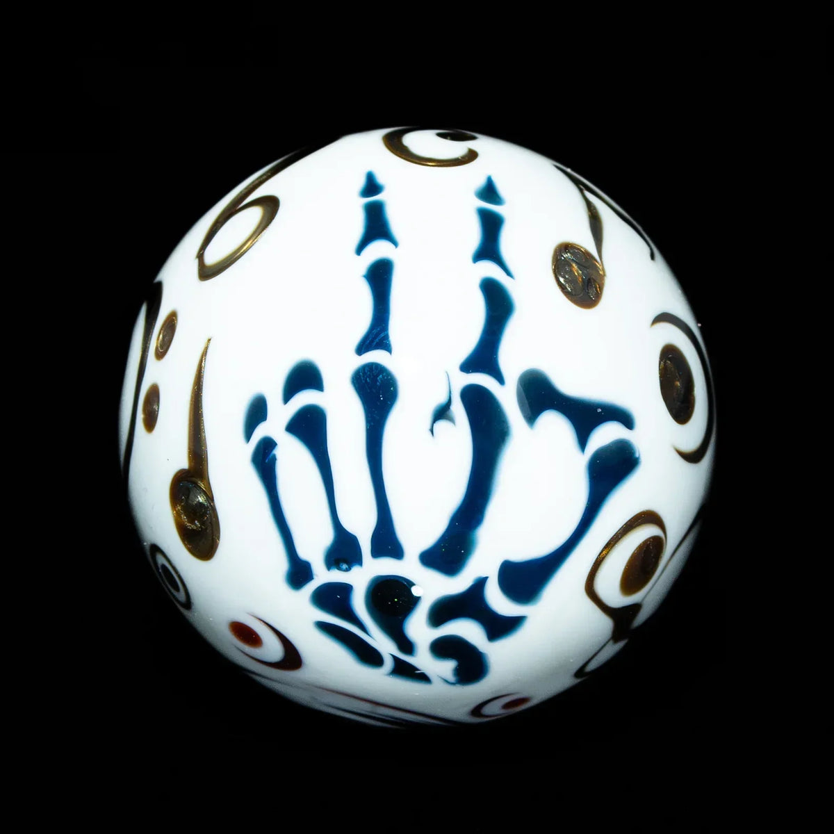 White marble glass sphere with blue skeleton hand and abstract gold circle designs