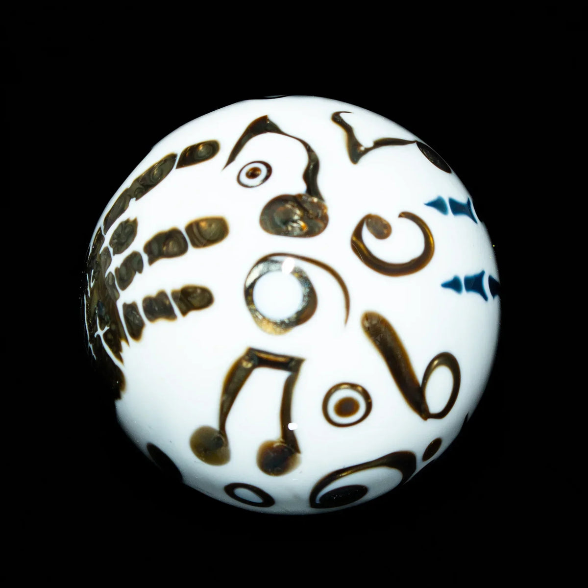 White glass marble with black abstract and musical note designs on black background
