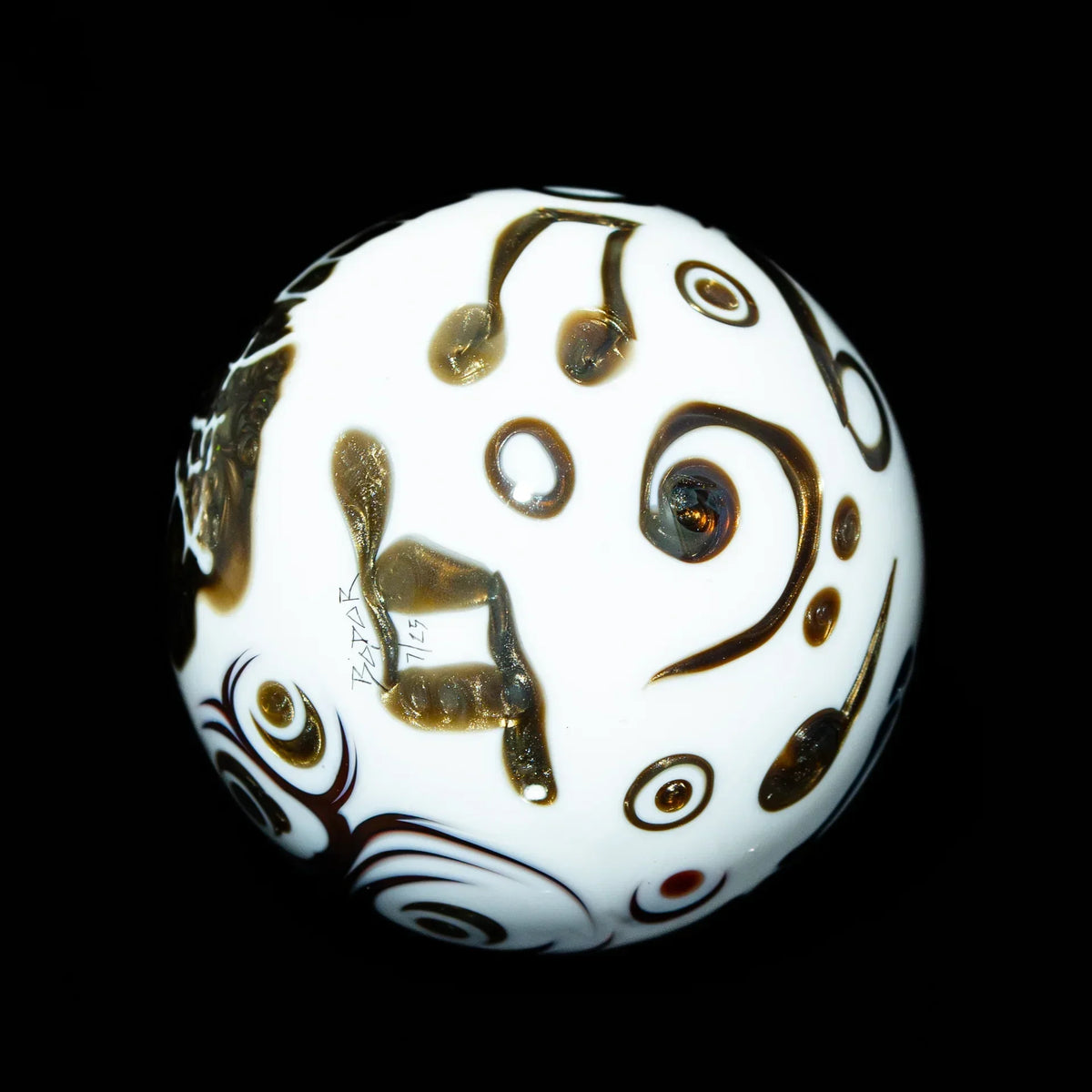 White glass marble with brown and gold abstract patterns on a black background