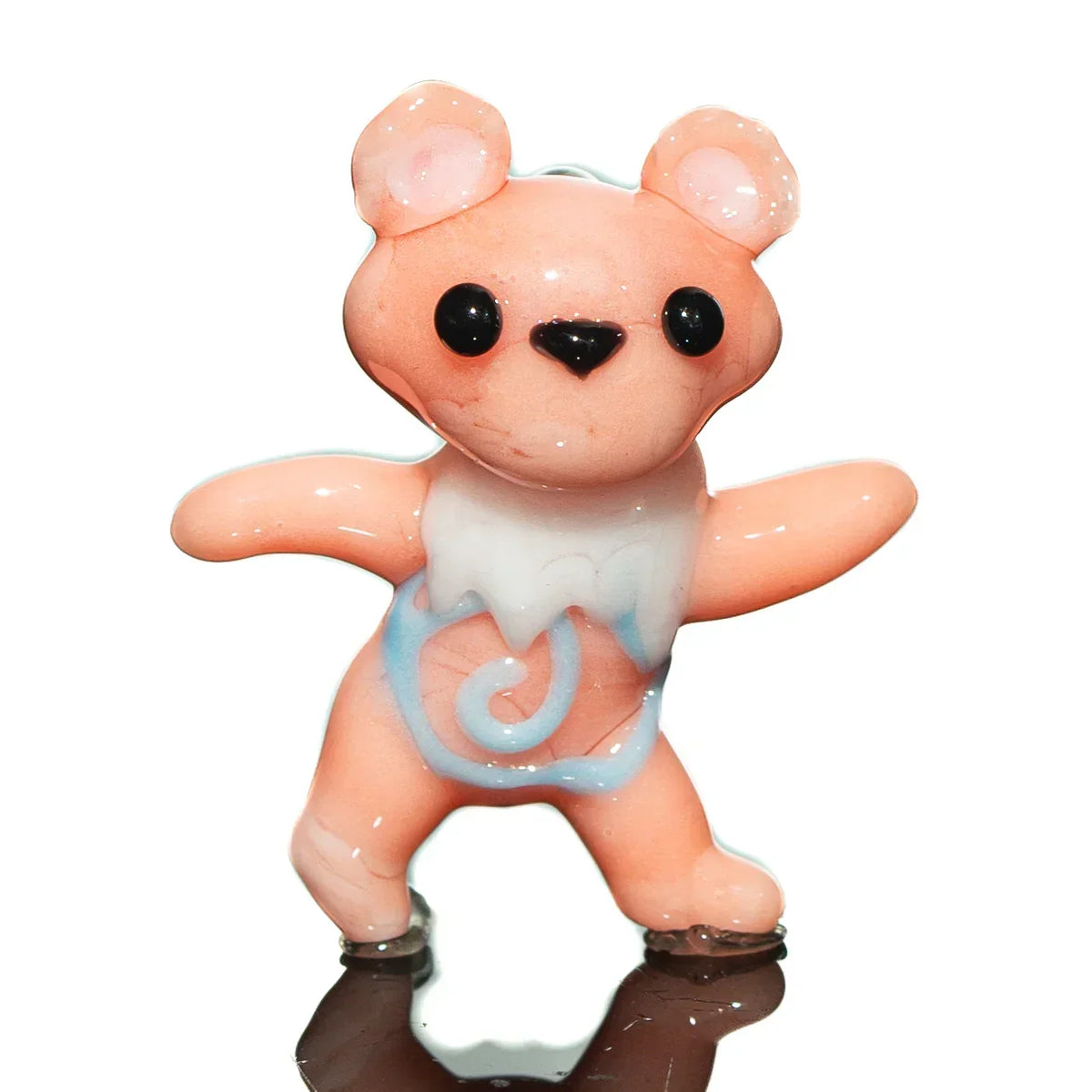 Handcrafted pink glass bear figurine with white and blue detailing on a white background