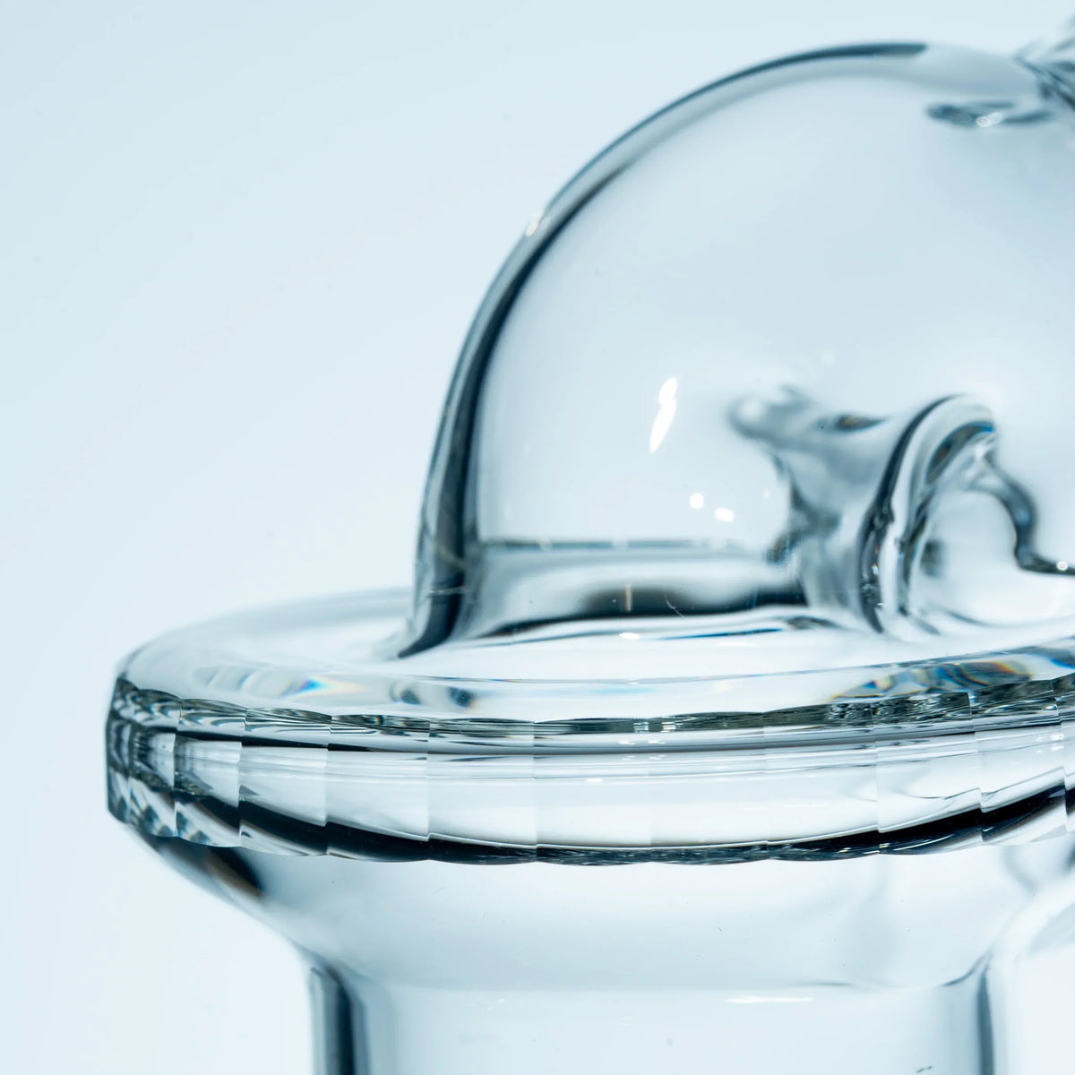 Close-up of clear glass carb cap with curved design for dab rig or vaporizer