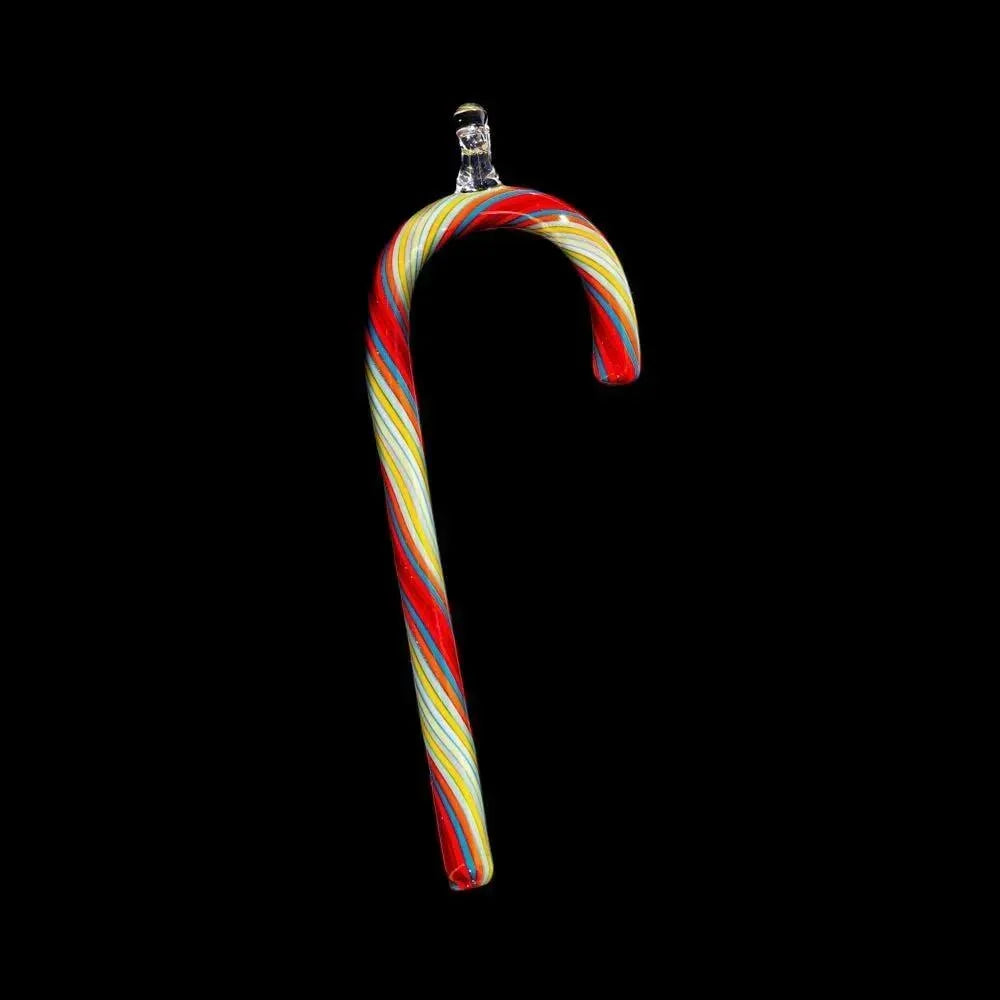 Hand-blown glass candy cane ornament with red, yellow, and white stripes on black background