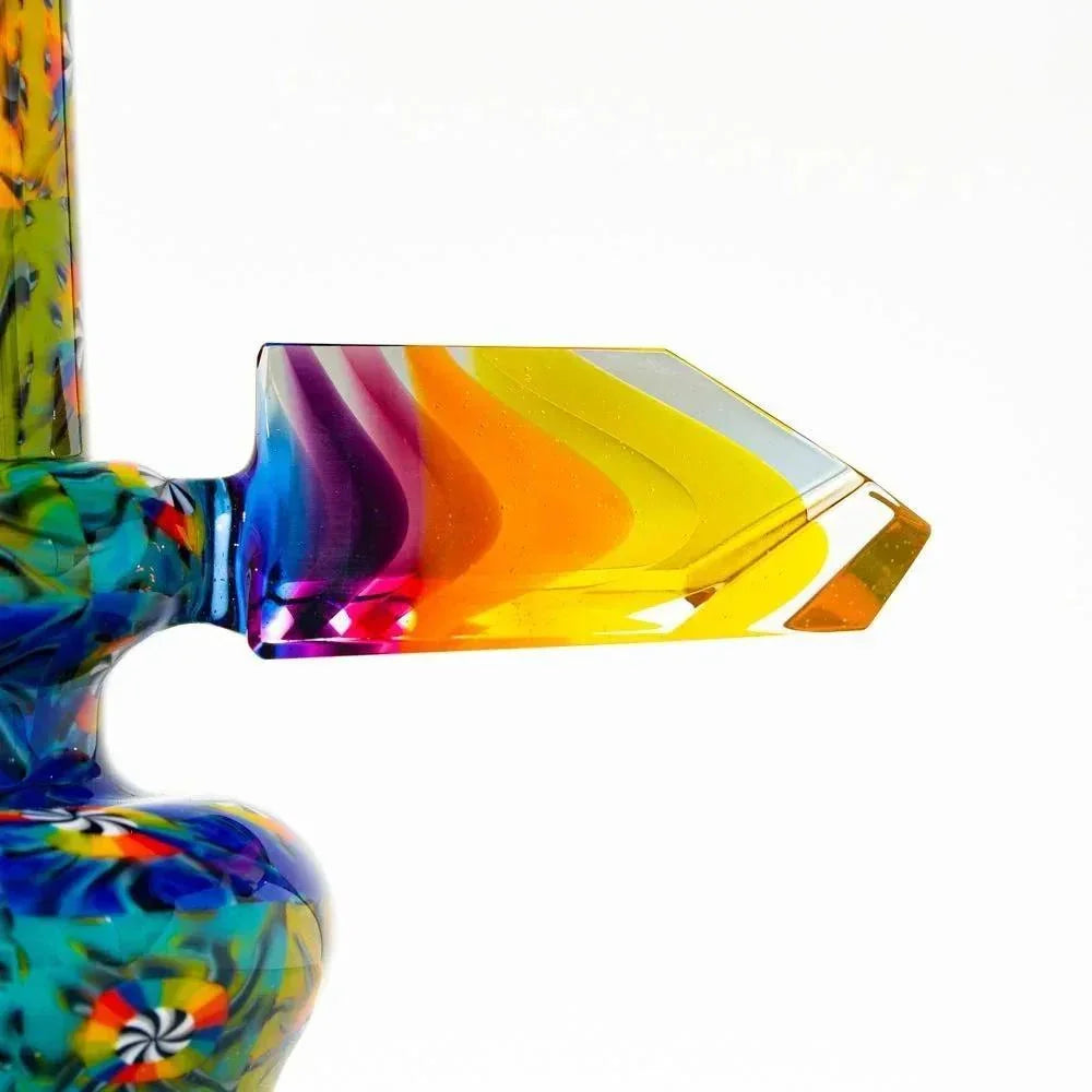 Colorful glass mini tube with vibrant swirled patterns and geometric handle detail