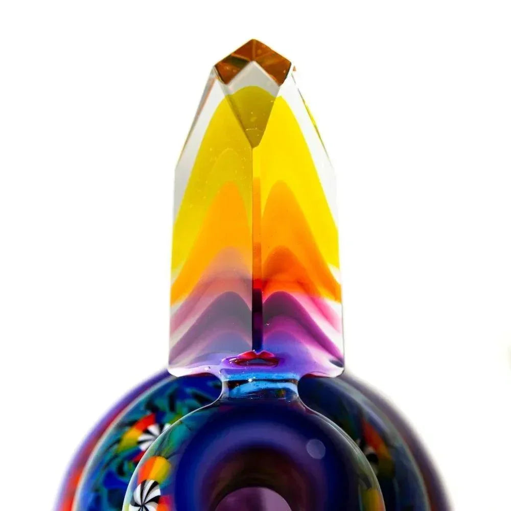 Colorful glass art pipe with a pointed crystal top and vibrant swirling patterns