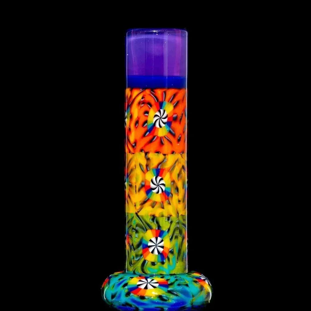 Colorful glass mini tube pipe with psychedelic patterns and swirl accents on black background.