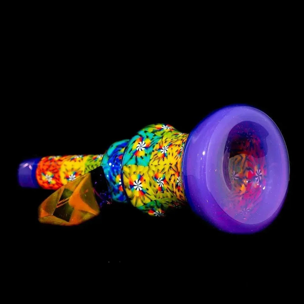 Colorful glass mini tube pipe with intricate patterns and a purple mouthpiece on black background